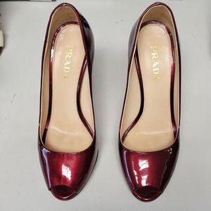 Prada ruby patent leather pumps